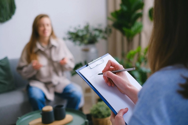 psychologist taking notes during appointment